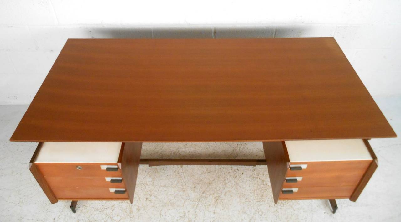 This beautiful Mid-Century desk offers a wonderful combination of style, storage and workspace, perfect for office or home. Floating top, modern drawer pulls and two-tone wood construction makes this a truly unique addition to any interior. Please