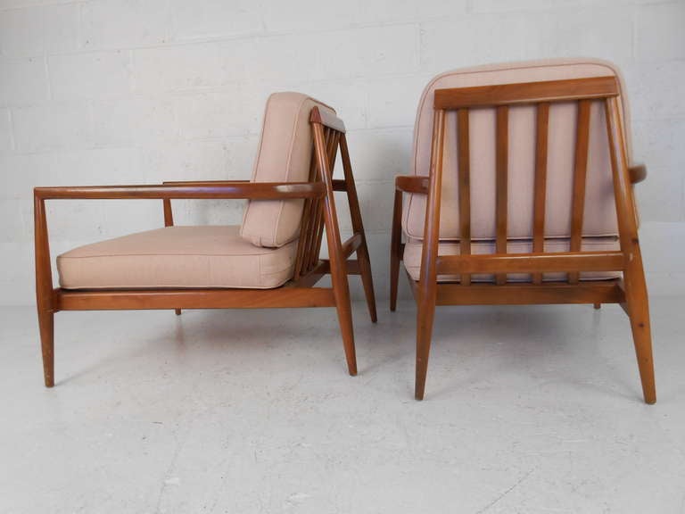 This stylish pair of walnut frame lounge chairs make a beautiful example of mid-century modern design. Similar tapered frame design to those made for Widdicomb for T.H. Robsjohn-Gibbings.

Please confirm item location (NY or NJ) with dealer.