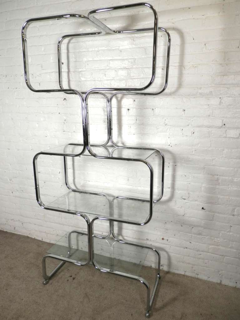 Tall shelving unit made of bent chrome and glass shelves. Made in Italy by Tricom. Very unusual, not the typical Milo Baughman square shape unit.

(Please confirm item location - NY or NJ - with dealer)