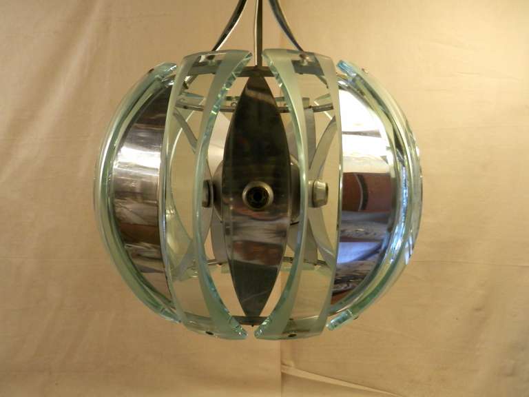 Mid-century globe-shaped pendant chandelier made up of alternating glass and chrome panels. Truly unique style and shape. The reflective panels concave and convex from the center.

(Please confirm item location - NY or NJ - with dealer).