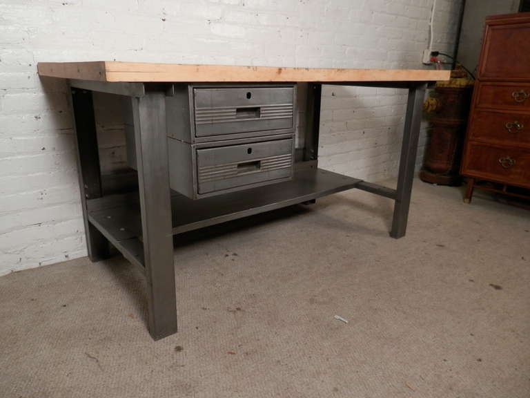 One of a kind work desk from the early 20th century. Made of heavy industrial metal with a butcher block top, all refinished. Pulled from an old factory, we have stripped the metal base and refinished the top, giving new life to this