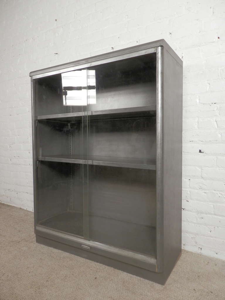 Factory quality shelving unit with glass pane doors made by the Columbia Co. Newly stripped to a handsome bare metal finish, this is now adaptable for your home or office use.

(Please confirm item location - NY or NJ - with dealer)