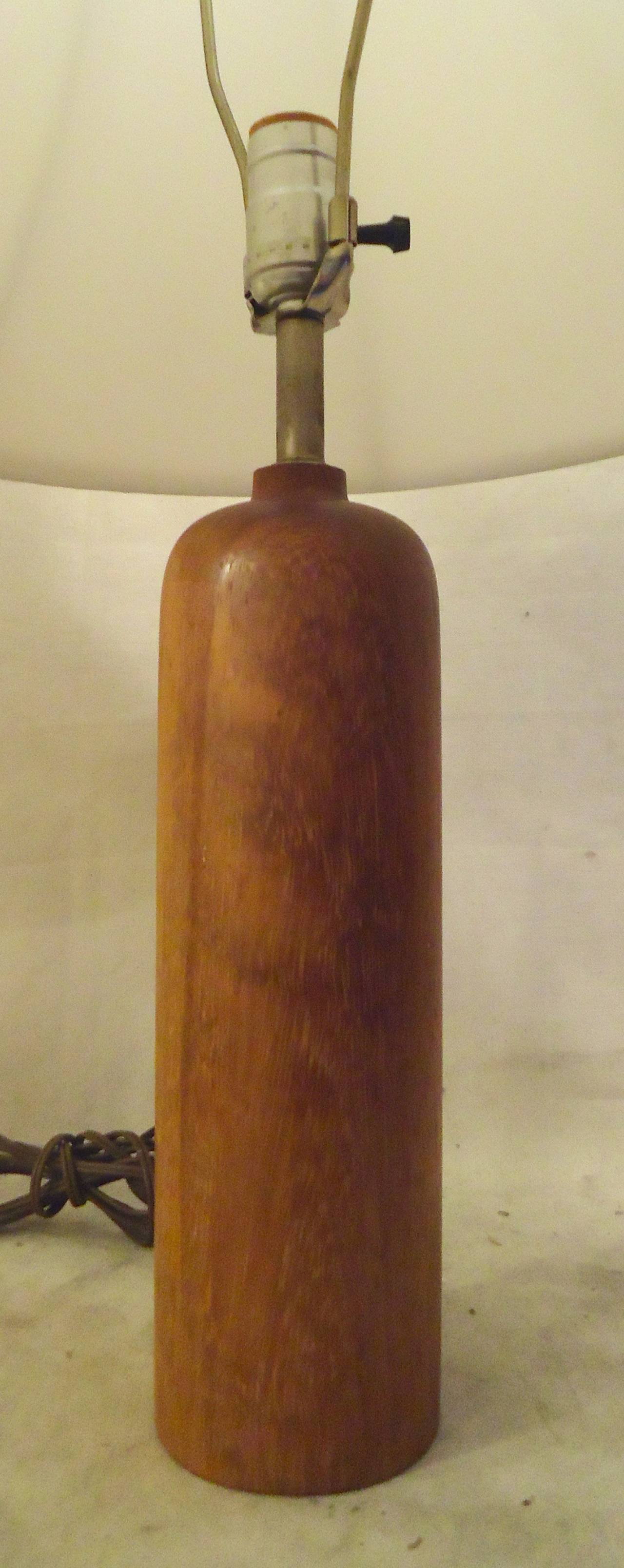 Sculpted teak wood table lamps with shades. They have a simple and sleek design.

(Please confirm item location - NY or NJ - with dealer)