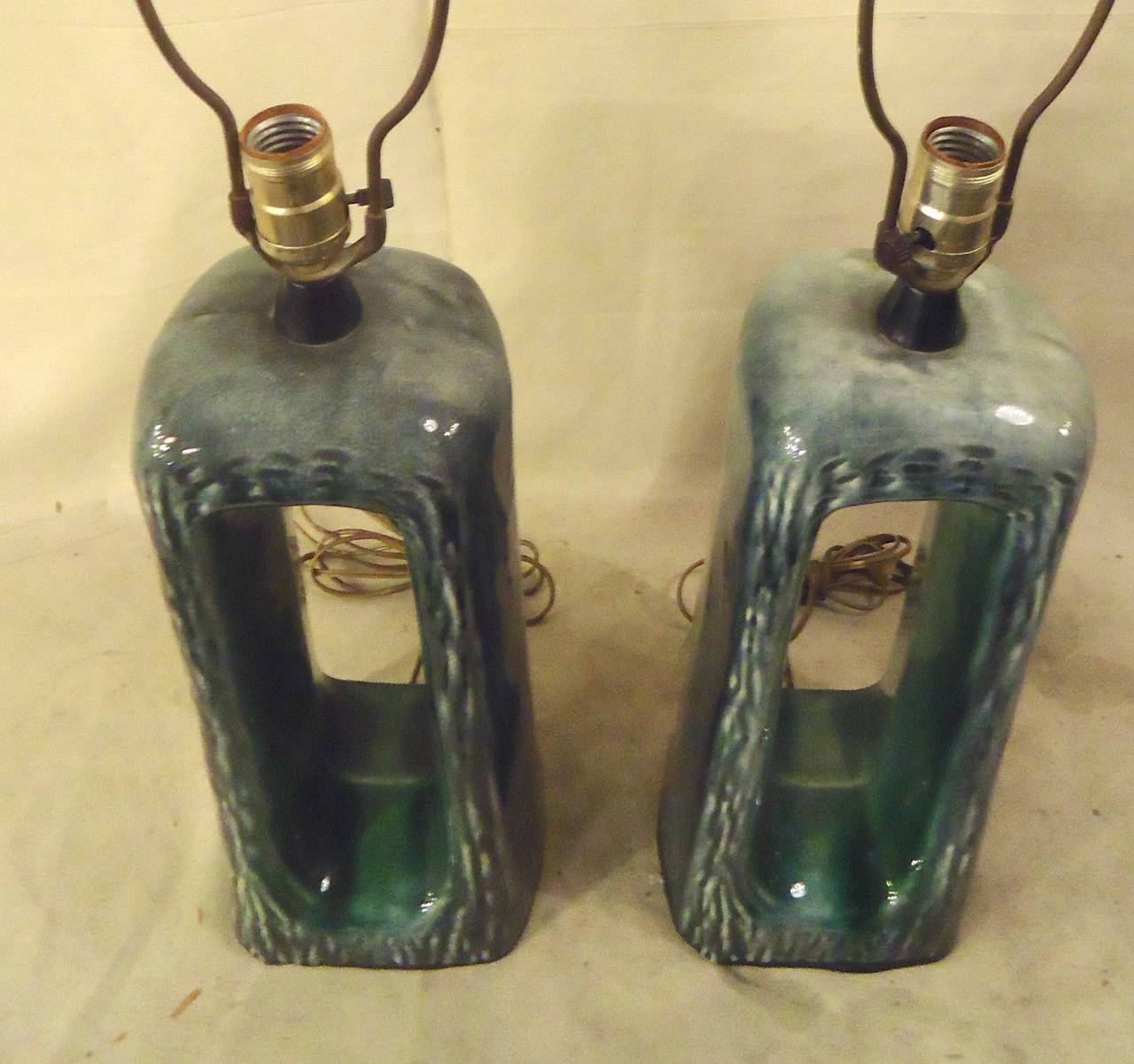 Pair of vintage modern table lamps by Heifetz of NY. Nice green, blue and grey coloring, with a sculptural element.
Height is 16