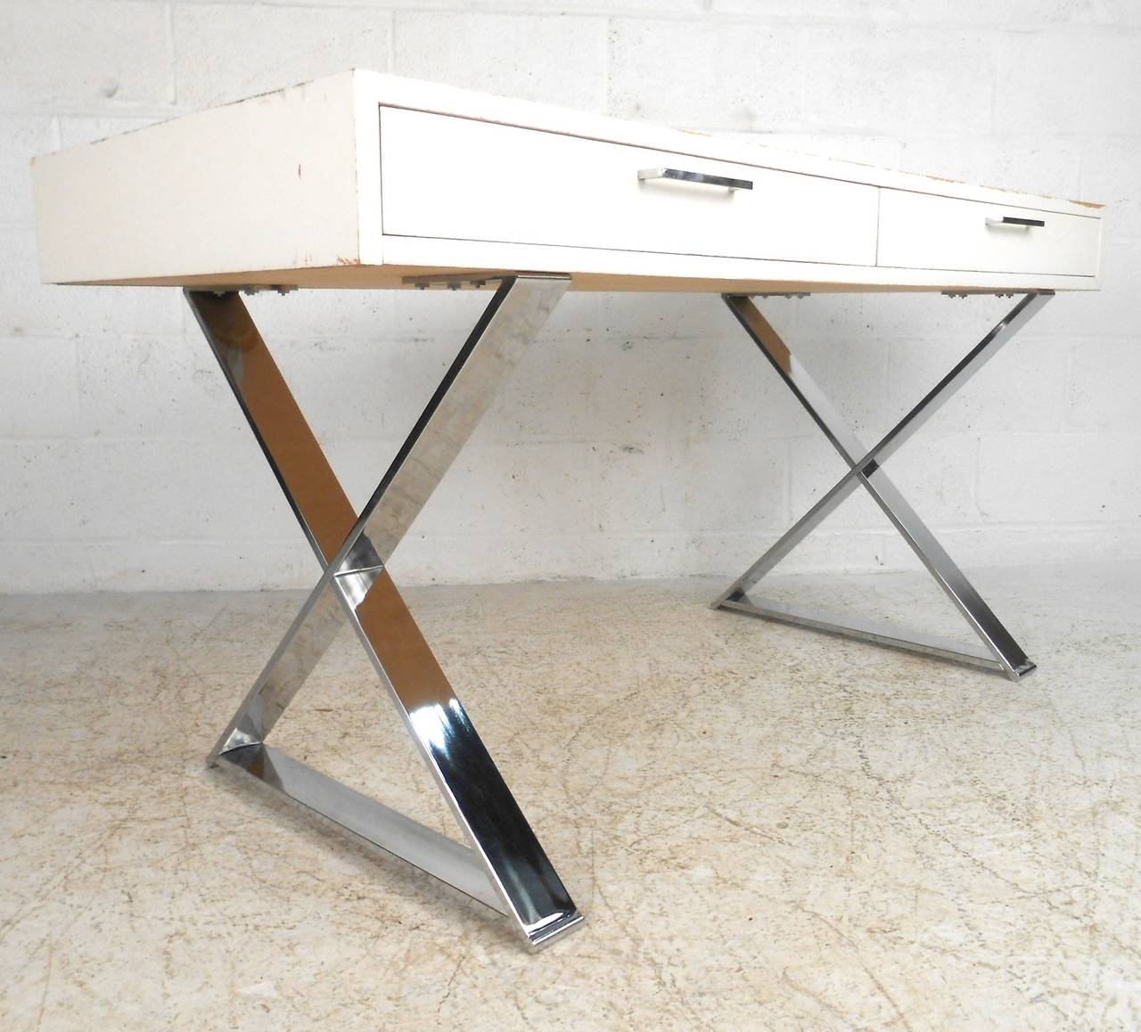 This unique vintage desk features a unique chrome base topped with a large workspace perfect for any setting. Pair of drawers offer added storage, wonderful addition to home or office. Please confirm item location (NY or NJ).