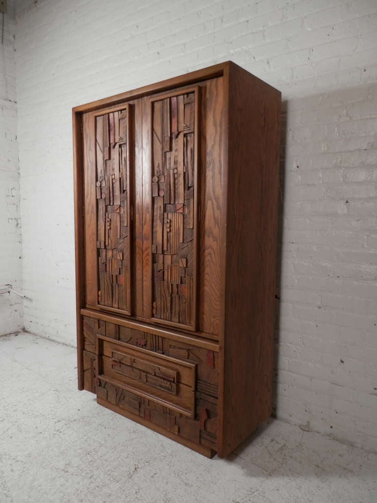 American tall dresser by Lane furniture company in the style of Paul Evans. Two door cabinet opens to shelving and two drawers. Two large bottom drawers. Beautiful unique 