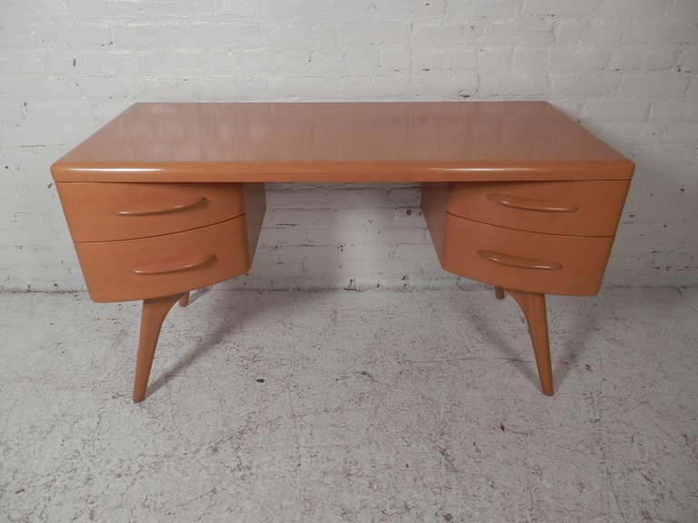 Beautiful mid-century desk by Heywood Wakefield with steam bent drawers with gracefully arched legs. The exaggerated, tapered design perfectly embodies the whimsical spirit of the 1950's as much or more than any item they produced. 

(Please