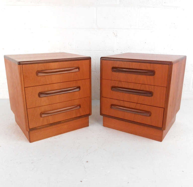 This beautiful pair of teak nightstands designed for G-Plan Furniture by Victor Wilkins in the 1960's features wonderful natural teak construction and expertly crafted drawer pull design. 

Please confirm item location (NY or NJ).