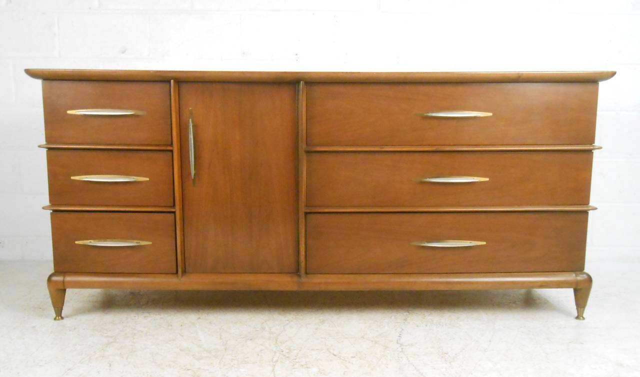 This unique vintage walnut dresser by Kent Coffey is from his 