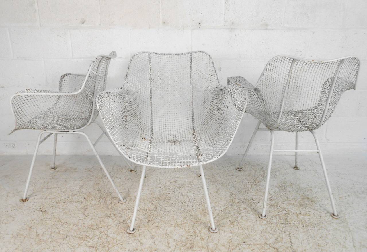 This classic four-piece set of mid-century chairs makes a wonderful addition to modern outdoor/indoor settings, featuring the creative style of Russell Woodard. Please confirm item location (NY or NJ).