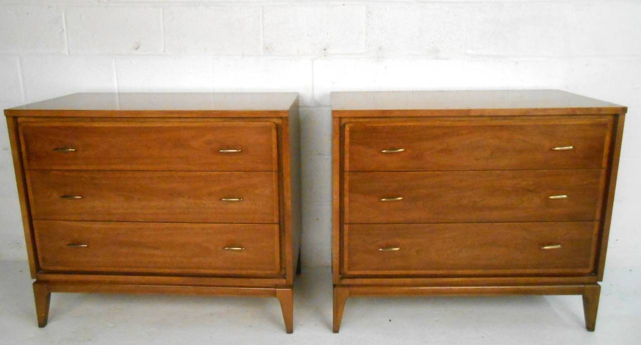 This pair of unique Mid-Century three-drawer dressers features unique tapered legs, quality construction, and wonderful drawer pulls. Perfect matching pair by Kent Coffey look great in any modern interior, original manufacturer's stamp. Please