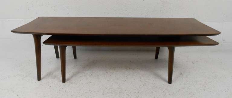 Unique two level coffee table in walnut with pivoting lower level. Please confirm item location (NY or NJ) with dealer.