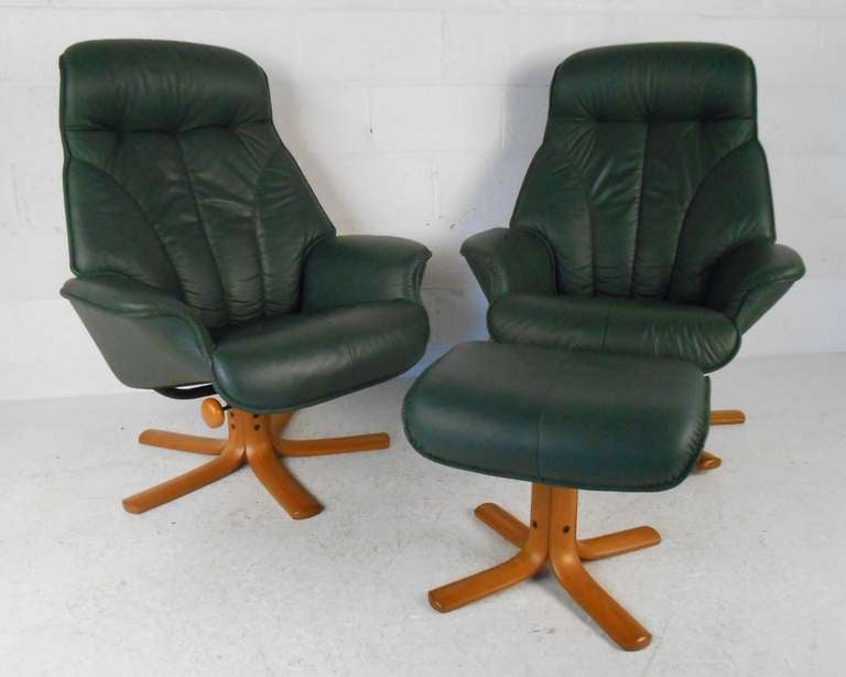 Pair of leather recliner with footstools by quality Norwegian furniture maker Hjellegjerde. Please confirm item location (NY or NJ) with dealer.