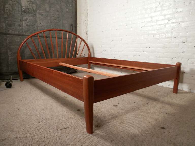 All teak bed frame made by Danish maker Jespersen. Arching headboard with spindle fan, thick tapering legs. Perfect match to your new mid-century bedroom set!

(Please confirm item location - NY or NJ - with dealer)