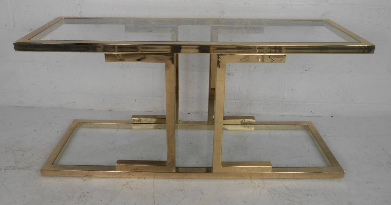 Beautiful, well-constructed, brass-plated console table with two glass shelves. Please confirm item location (NY or NJ) with dealer.