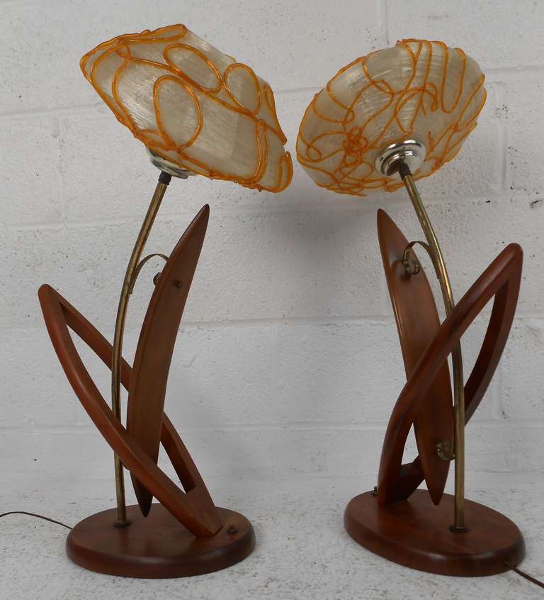 Pair of mid-century wood and brass plated metal lamps with orange & white spaghetti shades. Please confirm item location (NY or NJ) with dealer.