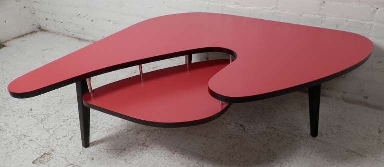 Vintage Atomic/Space Age style coffee table with floating shelf. Great red and black color contrast, exaggerated boomerang shape, and tapered legs. You won't see this one again anytime soon.

(Please confirm item location - NY or NJ - with dealer)
