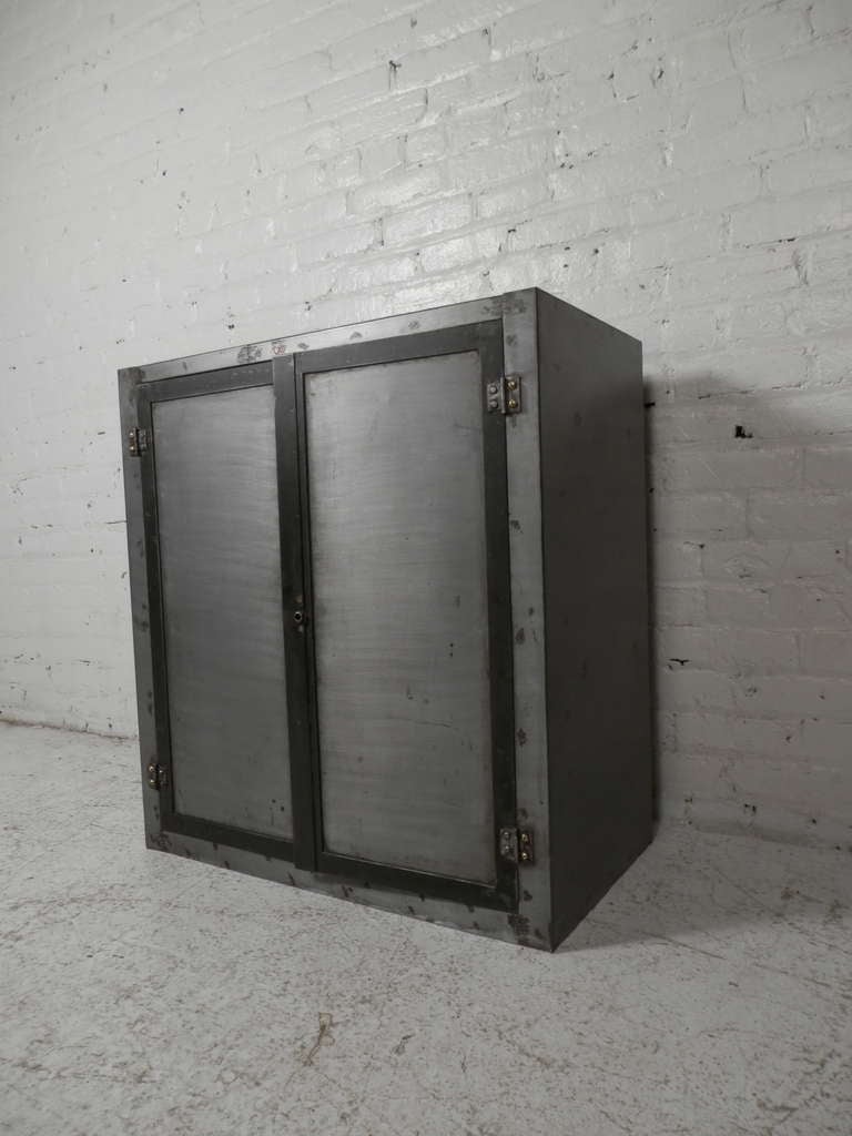 Heavy metal cabinet with inside storage compartments. Striped down to bare metal and lacquered for a handsome machine age style.

(Please confirm item location - NY or NJ - with dealer)