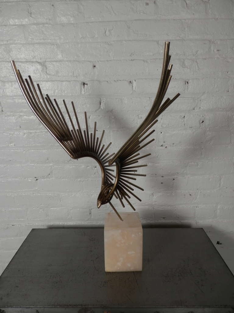 Table sculpture attributed to Curtis Jere. Heavy metal rods make up an eagle in flight posted in a solid marble base.

Curtis Jere is a compound nom-de-plume of artists Curtis Freiler and Jerry Fels. The two founders combined pieces of their own