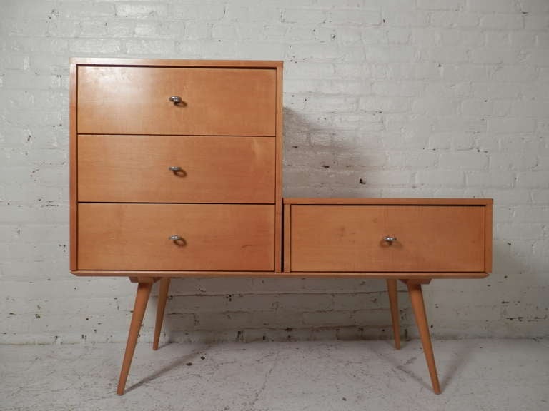 Maple drawers on a tapered leg platform with original ring pulls. Made by Paul McCobb for Winchendon Furniture. The two units sit on the coffee table style platform and can be arranged either way.

(Please confirm item location - NY or NJ - with