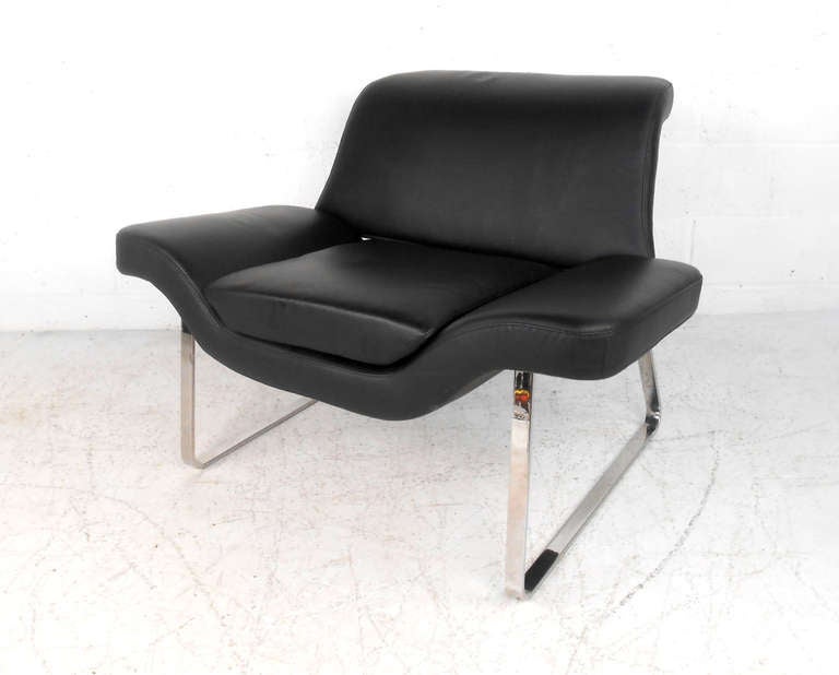 This beautifully covered club chair features rich black leather and a wonderful chrome frame. Unique design makes this chair a stylish and comfortable addition to home or business. Please confirm item location (NY or NJ).