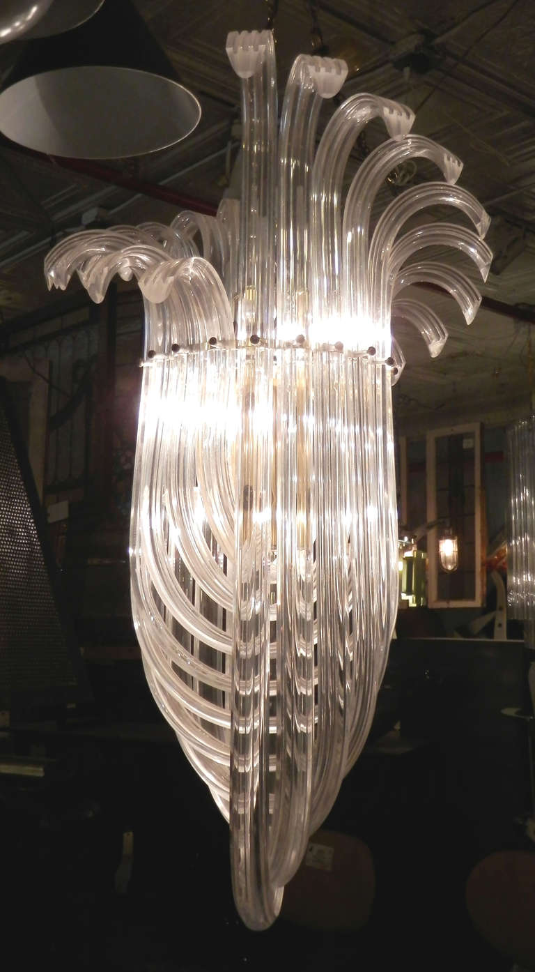Large chandelier made of swooping Lucite rods swagged and looped around for a dramatic and stylish design. Very unusual with exaggerated flairs at the top. Lights up brilliantly once nicely polished.

(Please confirm item location - NY or NJ -