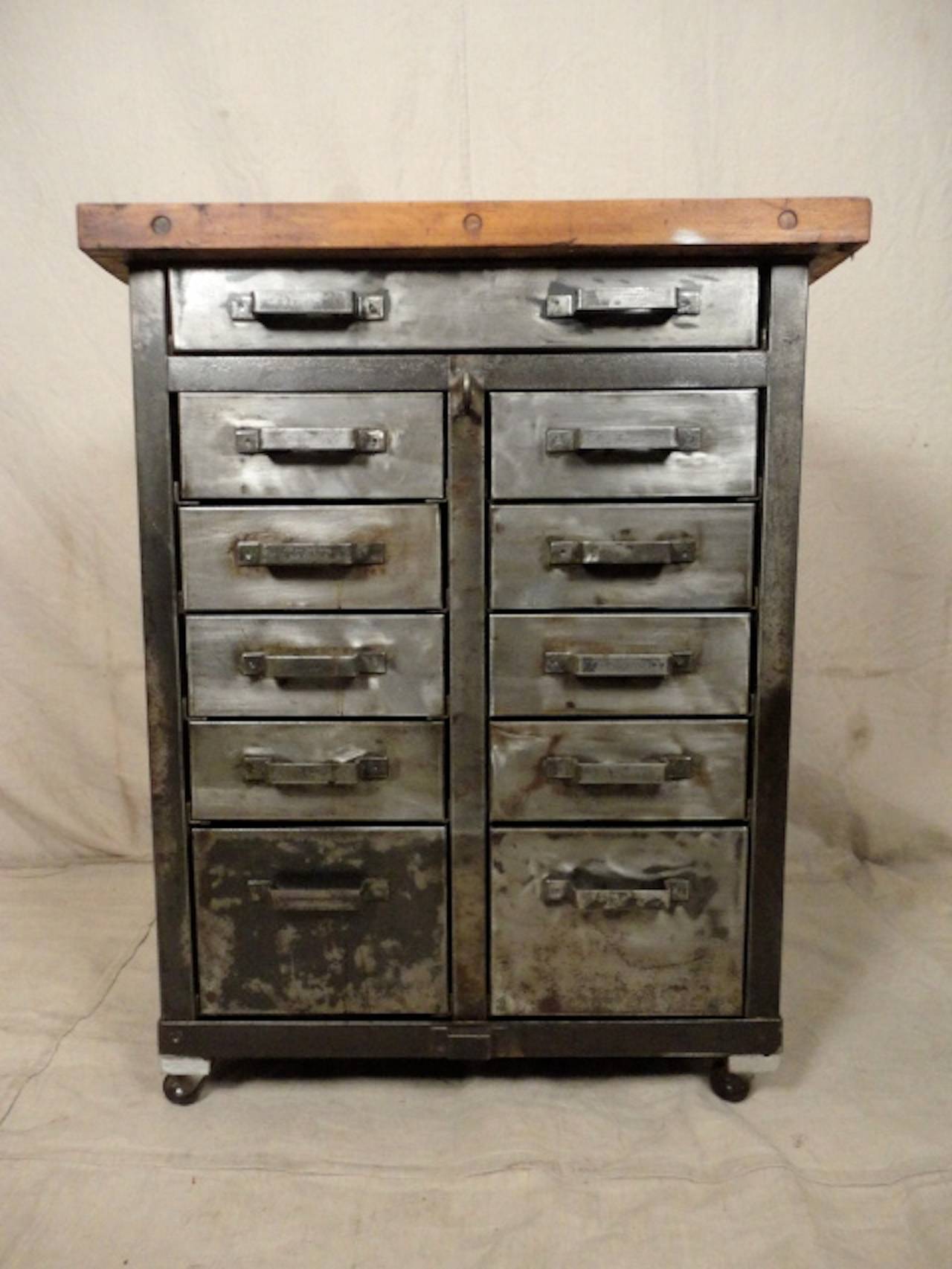 Unusual Industrial metal cart on casters with wonderfully aged butcher block top. Eleven multi-size drawers all with metal handles. A handsome addition to your kitchen.

(Please confirm item location - NY or NJ - with dealer).