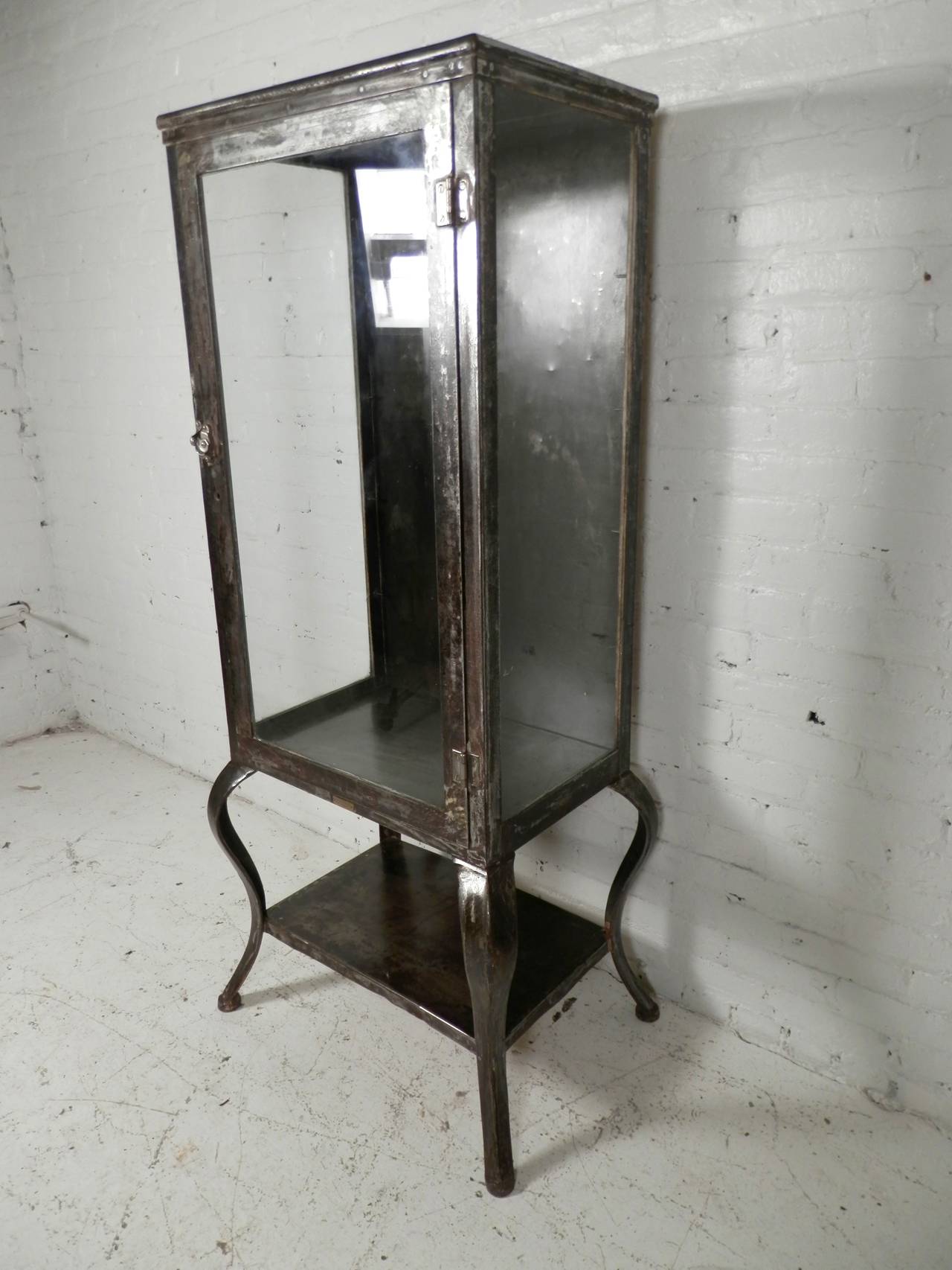 Industrial metal display cabinet with large visible cabinet. Completely restored in a stripped metal finish with sealant, to give an attractive factory look. Great for kitchen or bathroom storage.
Comes with three glass shelves not pictured, with