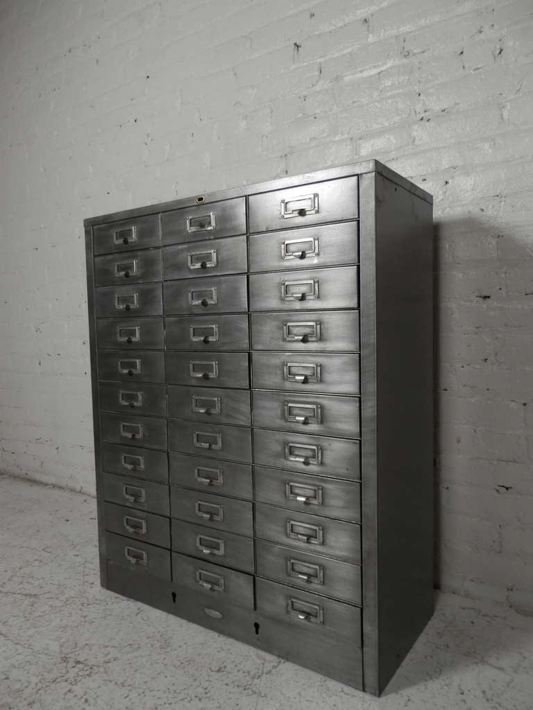 This beautiful thirty three drawer industrial metal file cabinet has been stripped, sanded, and lacquered to preserve its distinctive steel look.

(Please confirm item location - NY or NJ - with dealer)
