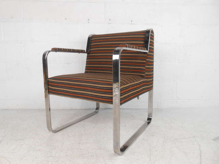 This wonderfully upholstered mixes comfort and fantastic design to create a stand out midcentury treasure for home or business. The sturdy chrome frame and uniquely shaped seat back showcase the quality of this vintage armchair. Please confirm item
