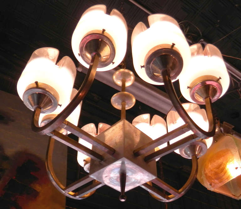 Fantastic Mid-Century chandelier by Italian maker Mazzega with superb Murano glass shades. Brass fixture holds eight unique globes, made in varying colors of clear to white, with hints of orange, giving off a radiant but not harsh