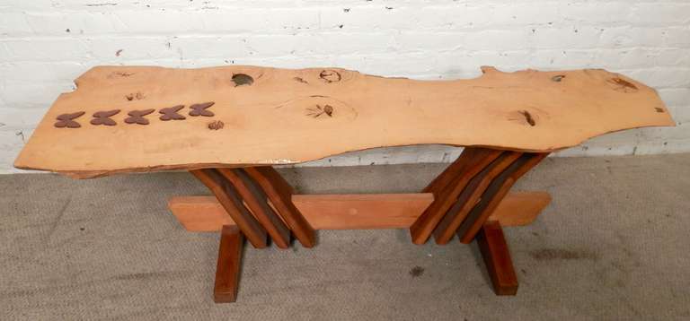 Wonderful table with splendid Nakashima style live edge finish and base. Delightful butterflies made of walnut, inlaid into a raw cut maple top. The base also has two tone wood coloring. Useful as a sofa table or bench.

(Please confirm item