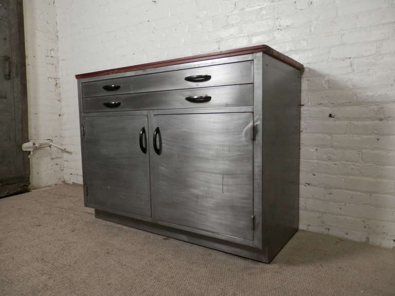 Large industrial metal cabinet with wood top. Good for use in kitchen or work space. Features two flat file drawers and two wide cabinet doors. Stripped to a handsome bare metal finish.

(Please confirm item location - NY or NJ - with dealer)