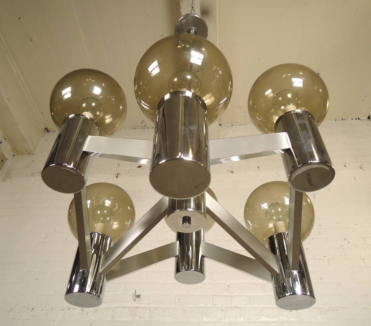 Unique vintage modern style chandelier featuring both polished and matte chrome with six smoked glass globes. Long chrome tube to the top ceiling flush mount.

(Please confirm item location - NY or NJ - with dealer)