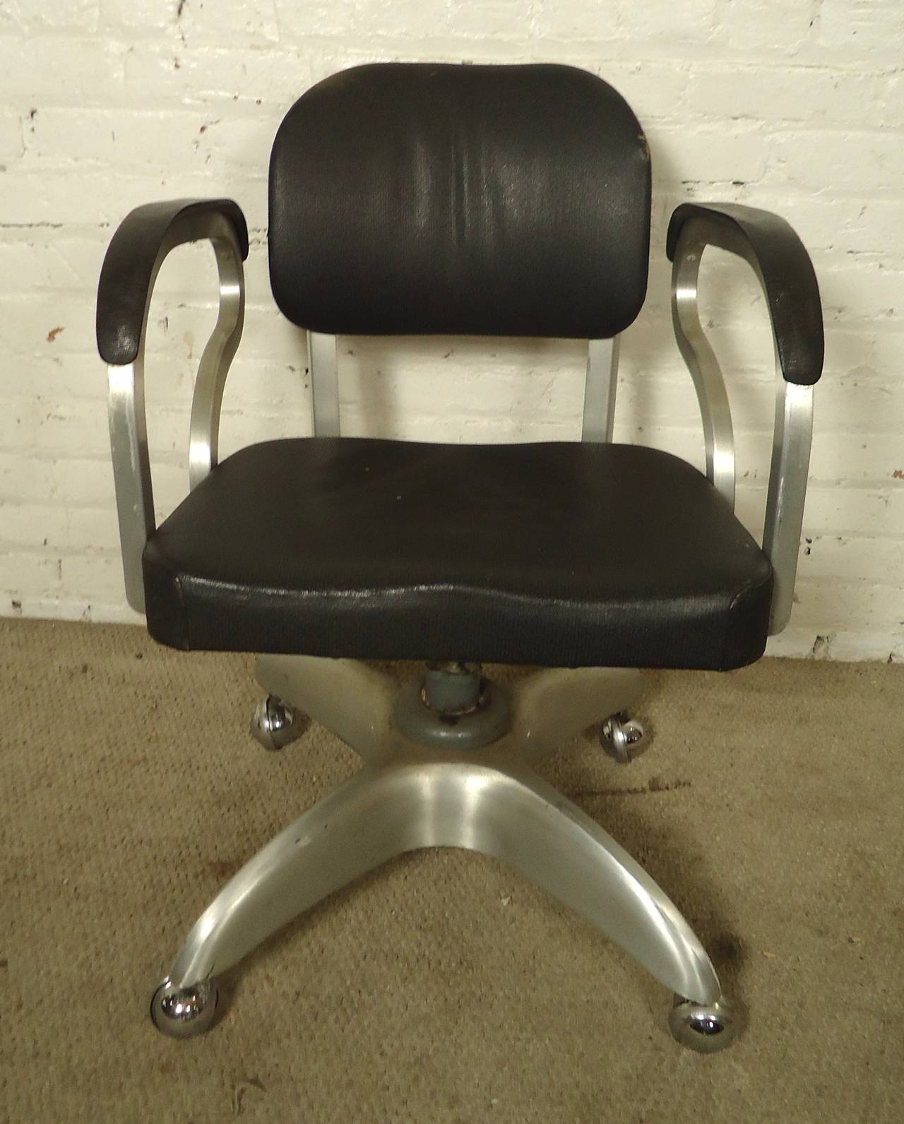 Vintage-modern desk chair featuring exaggerated arm rests, aluminum frame and wheeled swivel base, designed by Good Form. 

(Please confirm item location - NY or NJ - with dealer)