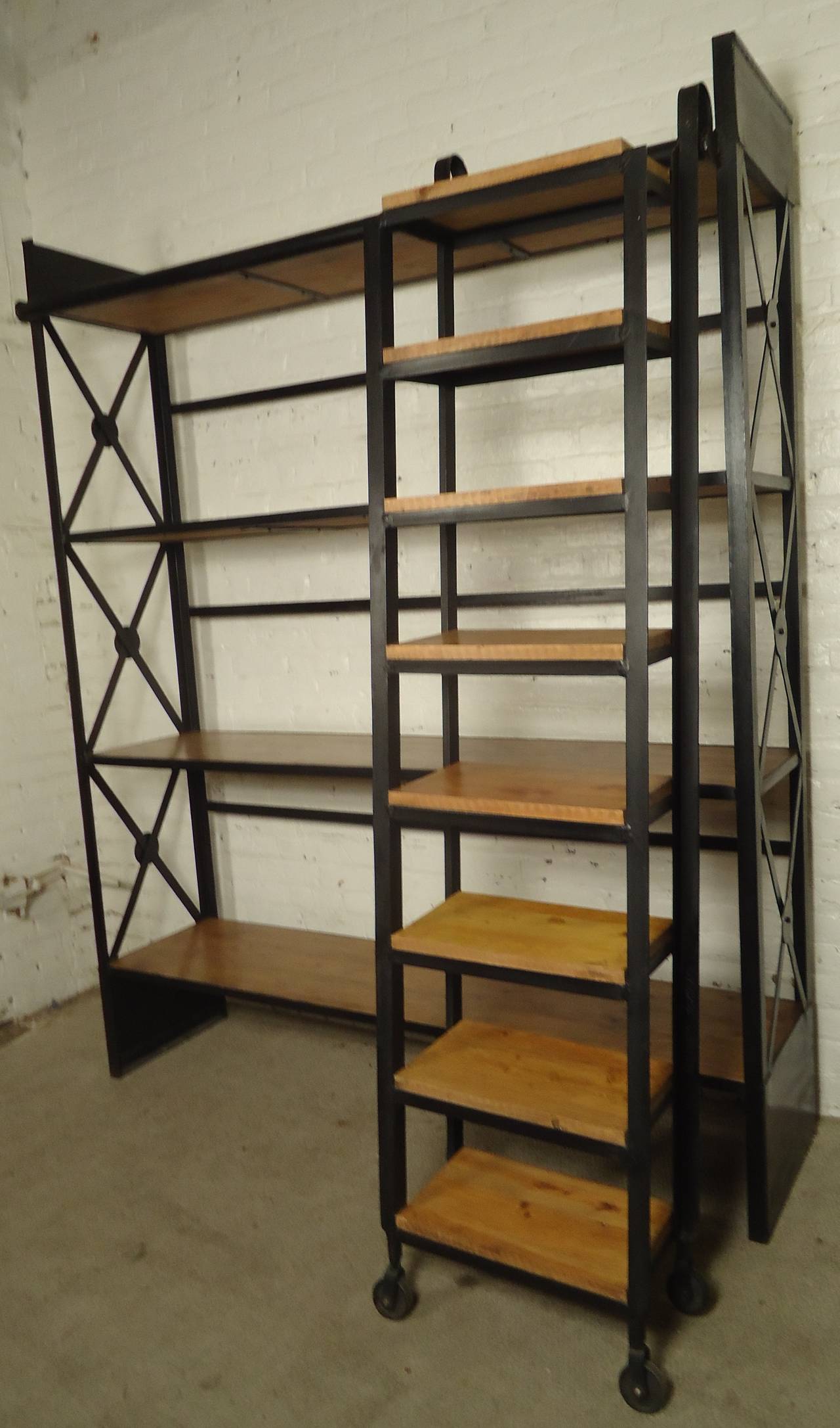 Industrial shelving unit featuring four long wooden shelves with an iron body. Eight step detachable ladder hooks onto top rail of bookshelf and slides left and right, wood steps with iron body and wheels.

Ladder dimensions - 20 W, 12 D, 80 H.