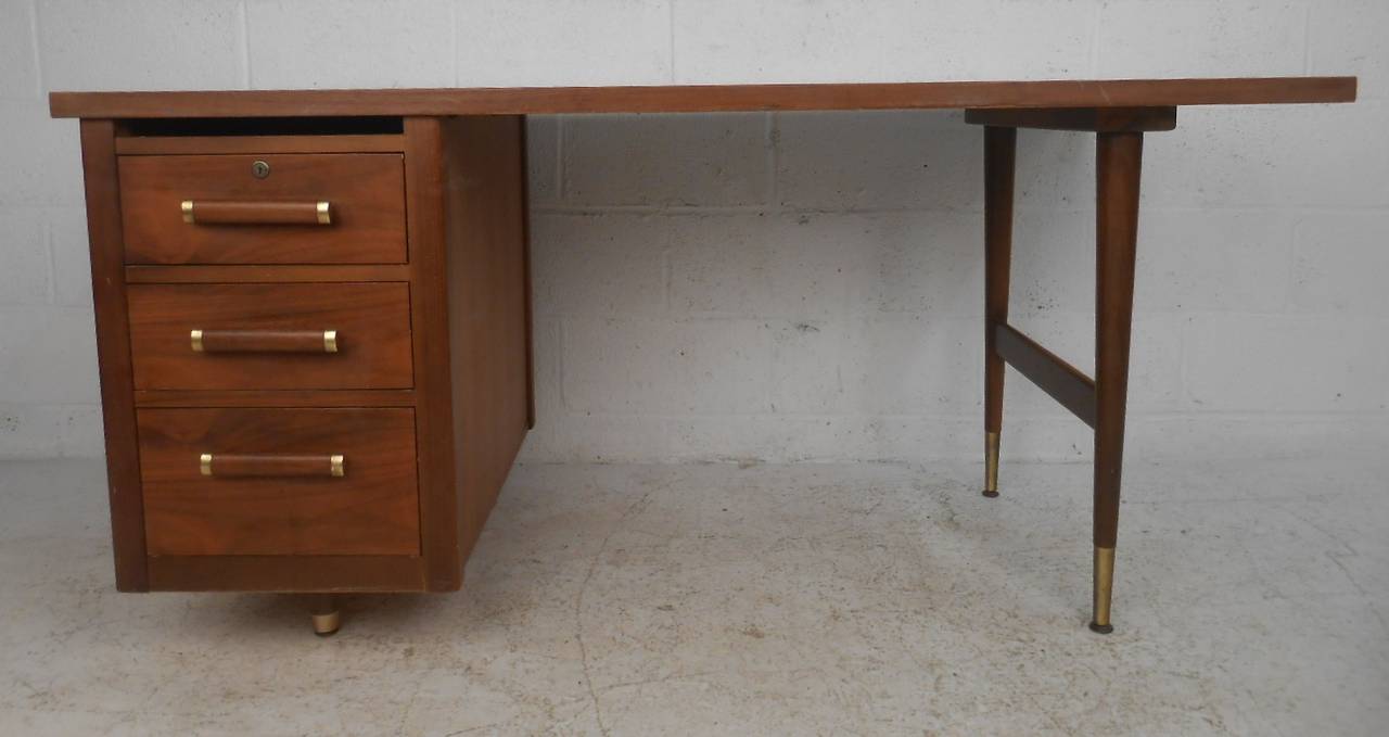 Three-drawer walnut single pedestal desk with brass-plated sabots and drawer pulls. Please confirm item location (NY or NJ) with dealer.