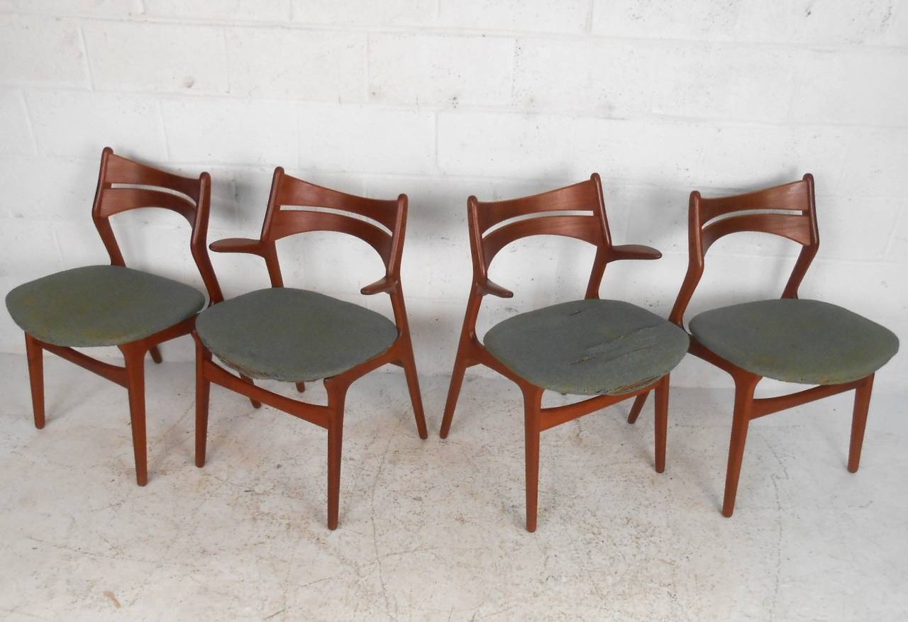 This gorgeous set of vintage teak dining chairs features wonderful sculpted seat backs, stabilizing stretchers, and a pair of extremely unique armchairs. Perfect combination of style and comfort, please confirm item location (NY or NJ).