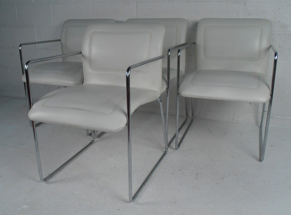 This stylish set of four vintage dining chairs feature comfortable upholstered seats and sleek Mid-Century Modern chrome frames. The clean lines on this matching set make an impressive addition to any dining room or kitchen table, and are