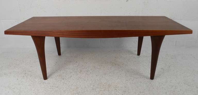 Mid-Century Modern coffee table in Scandinavian style table features sturdy construction in vintage teak. Please confirm item location (NY or NJ) with dealer.