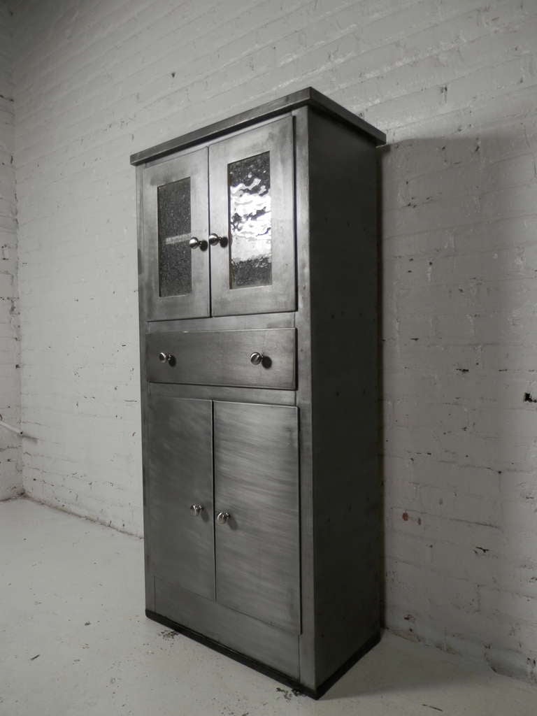 Industrial striped metal cabinet with crackled pattern glass doors. Cabinets open and shut by pulling the hardware out. Great storage unit.

(Please confirm item location - NY or NJ - with dealer)