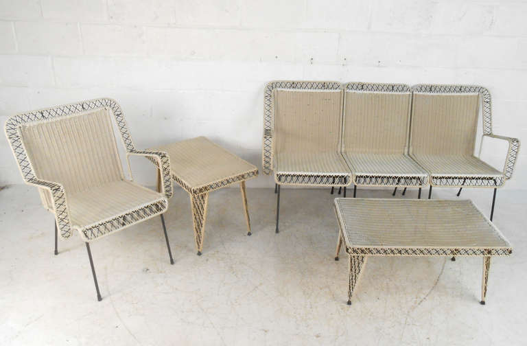 This matching patio set features woven spun fiberglass on sturdy cast iron legs. With arm chair, three piece settee, and two side tables all in good condition this vintage set makes a wonderful addition to patio or garden. 

Please confirm item