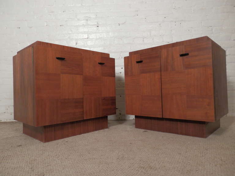 Large cabinet style side tables by Lane Furniture for their brutalist inspired Staccato series. Features lovely walnut grain in opposite patterns on two doors with black metal pulls. Cabinet space with adjustable shelf for extra storage