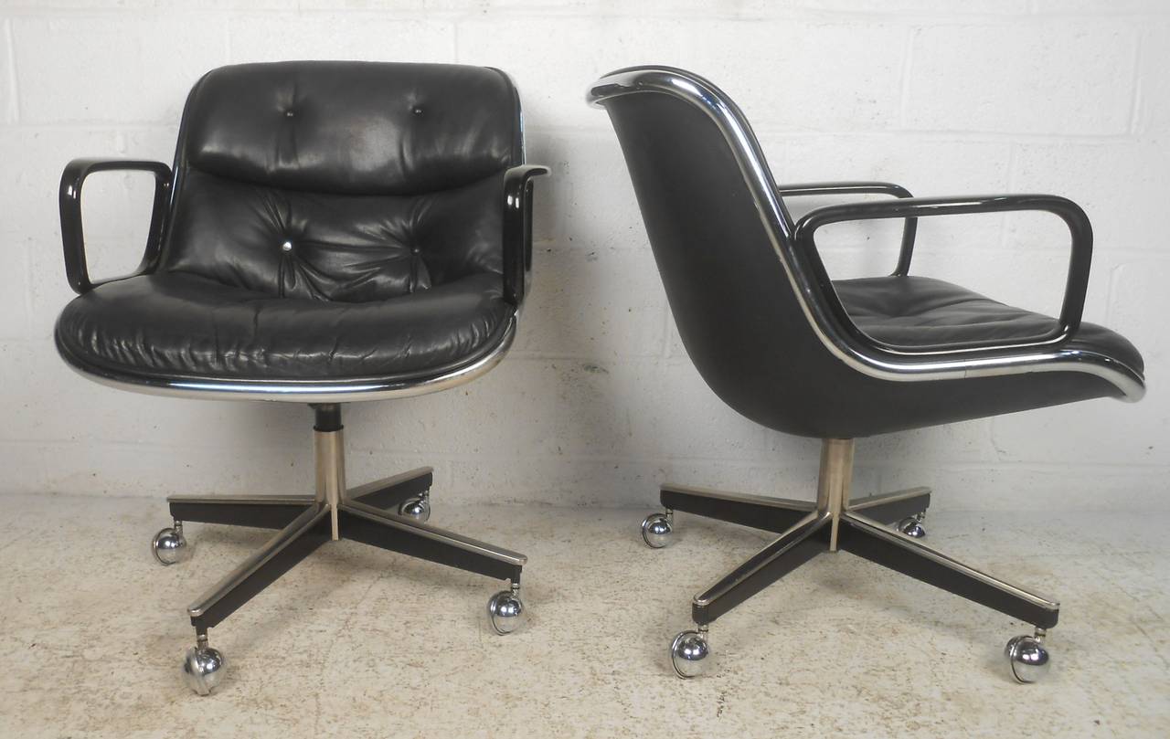 Pair of mid century leather executive chairs designed by Charles Pollock. A sleek and comfortable swivel design that makes the perfect addition to any setting. Please confirm item location (NY or NJ) with dealer.
