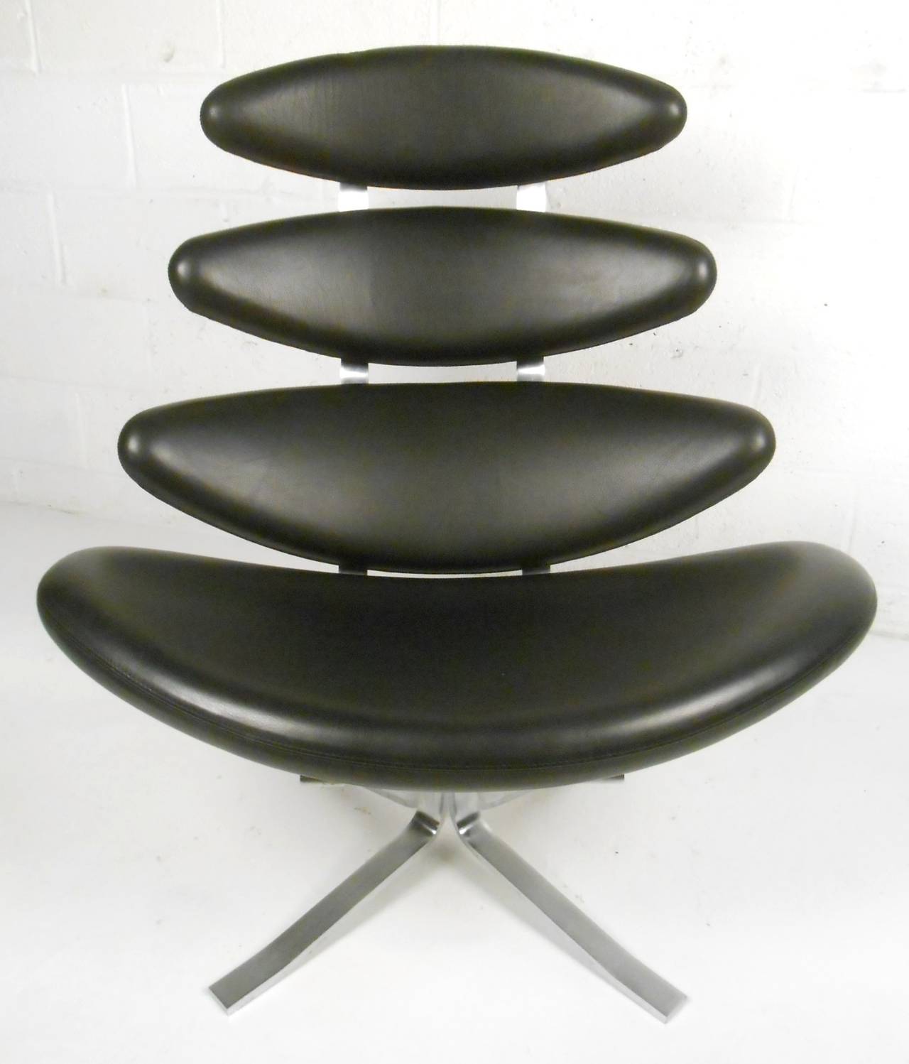 This unique midcentury Danish design makes a wonderful and eye-catching addition to any interior. Swivel leather lounge with sturdy, comfortable construction. Original manufacturer's label still in tact, please confirm item location (NY or NJ).