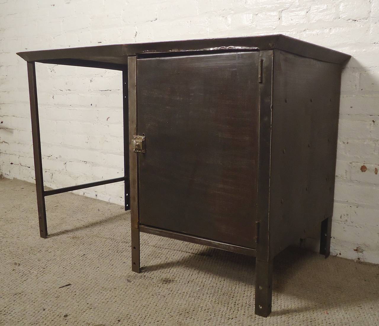 Vintage metal writing desk with a cool industrial appearance. Side door with three shelves, plus metal back that allows for center room placement.
Kneehole: 18"w 20"d 26"h

(Please confirm item location - NY or NJ - with dealer)
