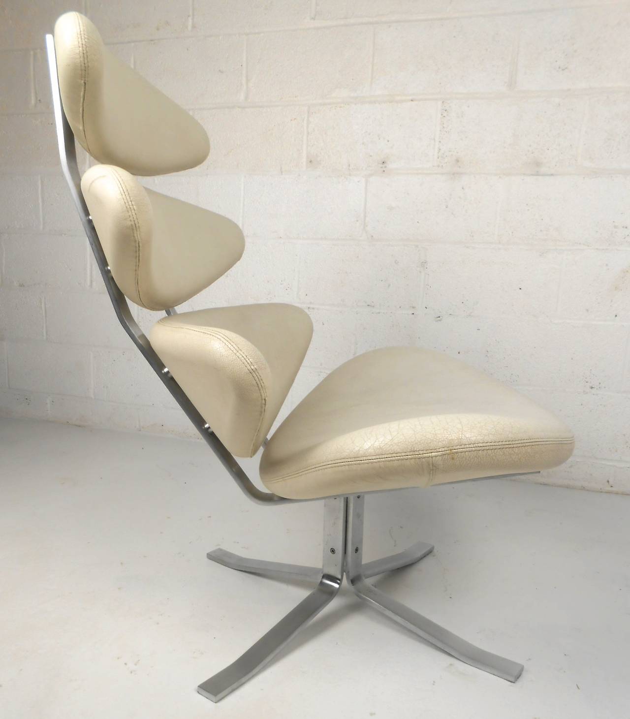 This beautifully designed vintage chair features wonderfully aged leather and the perfect mix of style and comfort. Unique design attributed to Poul Volther, swivel seat and high back make this a comfortable addition to any interior. Please confirm