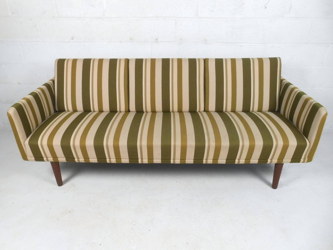 This beautiful Mid-Century sofa combines simple yet elegant lines with striking vintage upholstery. Unique yet subtle vintage Danish design makes this a wonderful addition to any modern interior. Please confirm item location (NY or NJ).