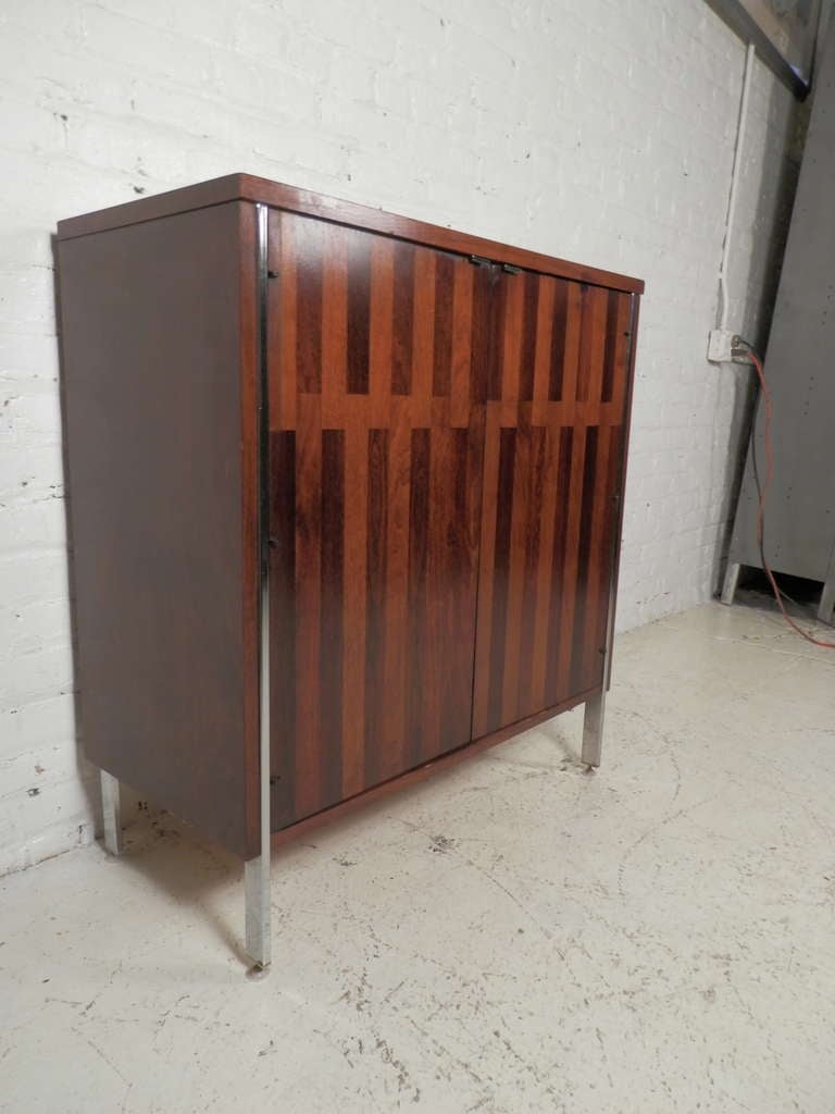 Vintage modern bar with inlay wood front, chrome legs that reach the top, and locking flip top that props open to reveal a black holding compartment.

(Please confirm item location - NY or NJ - with dealer)