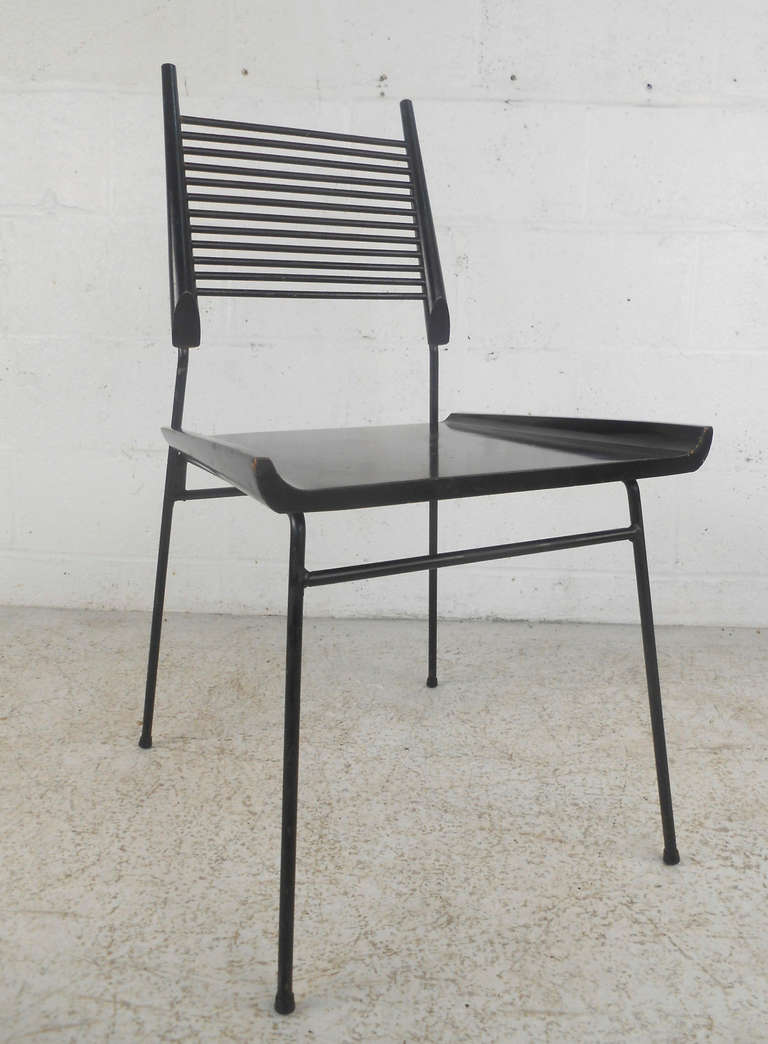 This Paul McCobb Shovel Chair from the Planner Group series features a sleek black finish and sturdy wrought iron legs. Please confirm item location (NY or NJ).